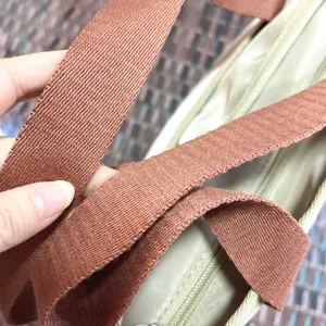 Detailed close-up view of the sturdy handbag strap and zipper for daily commuting.