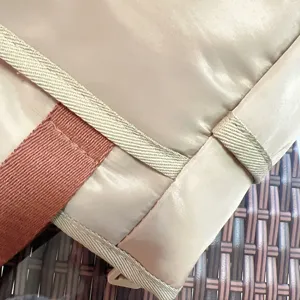 Close-up detail view of the stylish color-blocked handbag fabric, stitching and texture.