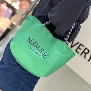 Green canvas tote bag for women large capacity casual commuter handbag minimalist style shoulder bag.