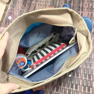 Interior detail of color-blocked canvas tote bag showing spacious capacity and compartments.