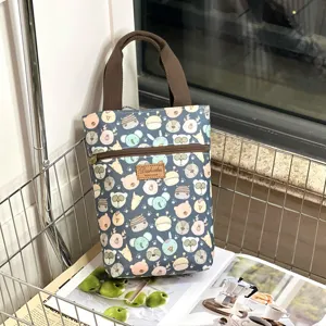Cute cartoon animal print waterproof handbag detail view with zipper and sturdy handles.