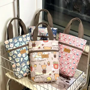 Detailed shot of waterproof cartoon tote bag with cute animal prints and handy zipper pocket.