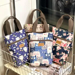 Waterproof cartoon handbag for daily use, cute cat and floral prints, practical storage bag.