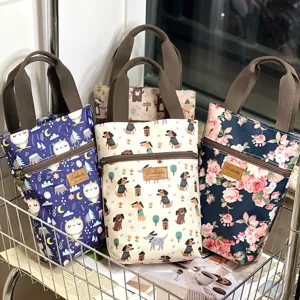 Waterproof canvas tote bag detail showing cute animal and floral prints with front zipper pocket.