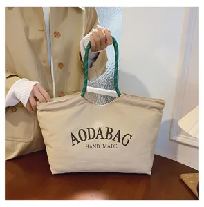 Gedetailleerde opname van Japanse stijl canvas tote bag met groene touw handvatten.