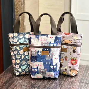 Waterproof canvas tote bag with cute cartoon prints, zipper pocket and sturdy handles.