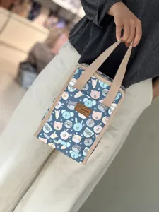 Cute cartoon animal print insulated lunch bag with comfortable handles for daily use.