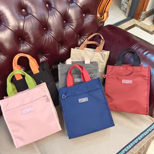 Colorful canvas lunch tote bag with front zipper pocket, portable handbag for office school work.