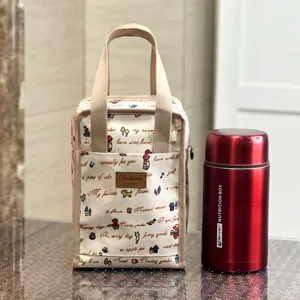 Insulated lunch bag for work, waterproof bento bag with cute doodle prints and sturdy handles.