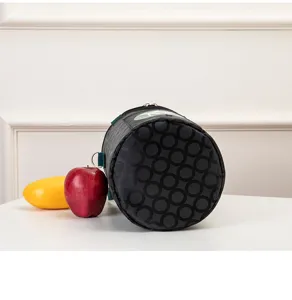 Cylindrical insulated lunch bag with black geometric circle pattern, durable bento storage.