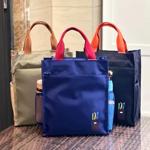Color-blocked multi-layer thickened tote bag for students commuting and cram school use.