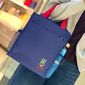 Blue multi-layer thickened tote bag with red handles and pencil pattern for daily commute.
