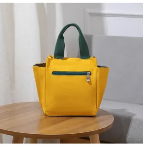 Gele canvas lunchtas voor dames, schattige Japanse bento tas detail met groene handgreep.