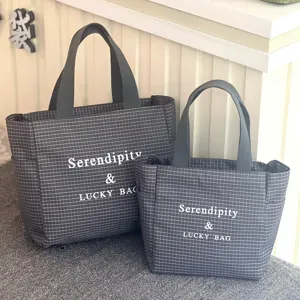 Detail view of the large capacity grid tote bag showing fabric texture and double handles.