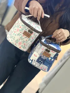 Portable waterproof lunch bag and cosmetic case with cute animal prints and secure zippers.