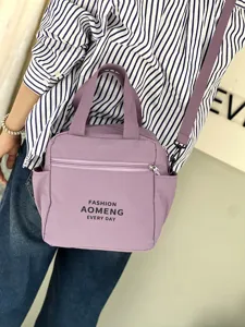 Waterproof thermal lunch bag with crossbody strap, stylish purple bento tote for daily commute.