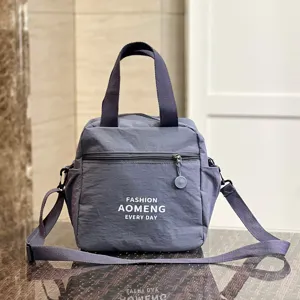 Waterproof insulated lunch bag tote with shoulder strap, casual grey commuting handbag for women.