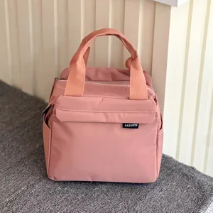 Pink waterproof insulated lunch bag detail, portable bento tote for daily office commuting.