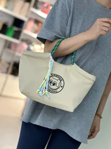 Waterproof canvas lunch bag with green rope handle and cute cartoon bear print detail for daily use