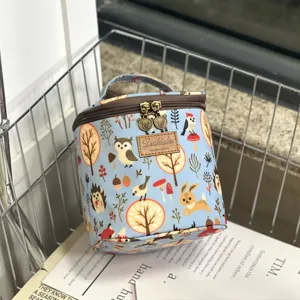 Waterproof cylinder cosmetic bag detail featuring cute woodland animal print and convenient handle.