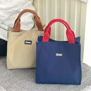 Canvas lunch bag with stylish color-block handles, large capacity daily tote handbag for work and school.