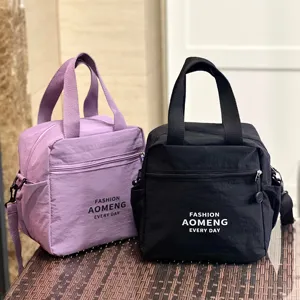 Detailed view of insulated lunch bag with shoulder strap and multiple pockets for daily commute.
