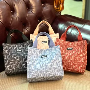 Detailed view of large capacity canvas lunch tote bag with stylish monogram pattern and sturdy handles.