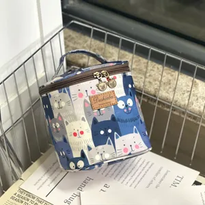 Waterproof insulated lunch bag and cosmetic case with cute cat pattern design, durable and portable.