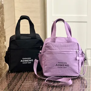 Waterproof insulated lunch bag with shoulder strap, dual-use tote for daily commute and work.