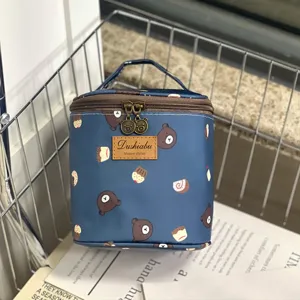 Detail view of waterproof insulated lunch bag with cute bear pattern, portable cosmetic storage.