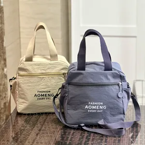 Detailed view of dual-use waterproof insulated lunch bags in beige and grey with shoulder strap.