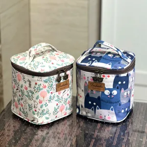 Waterproof portable cosmetic bag and lunch storage case with cute cartoon cat and floral prints.