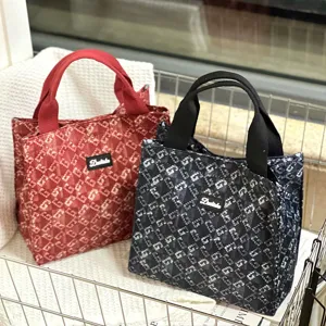 Large canvas lunch bag with trendy monogram print, durable top handle and zipper.