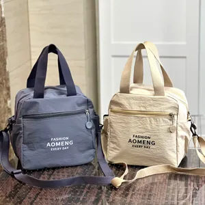 Waterproof insulated lunch bag tote with crossbody strap and cup holder for daily commute.