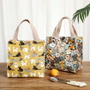 Waterproof canvas lunch bag for office workers and students with cute cat prints and sturdy handles.