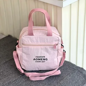 Waterproof insulated lunch bag for women, pink commuter bento bag with shoulder strap.