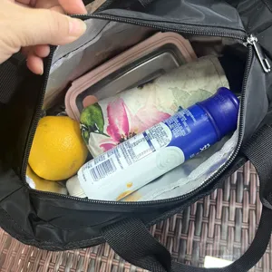 Detail view of the black insulated lunch bag showing large capacity interior storage capacity.