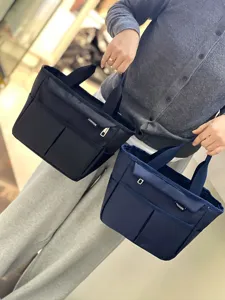 Multi-pocket waterproof lunch tote bag, large capacity stylish handbag for daily commuting.