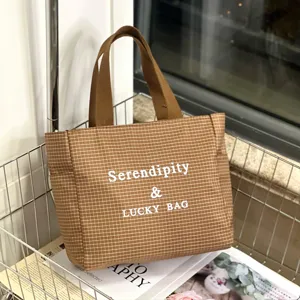 Brown grid canvas tote bag detail, casual commuting handbag with letter print, large capacity use.