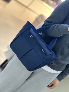 Dark blue multi-pocket waterproof lunch tote bag, casual commuter handbag with dual handles.