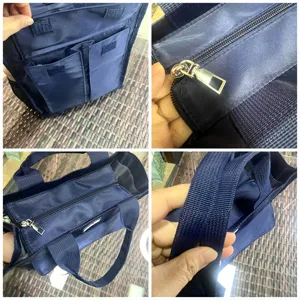 Close-up details of the multi-pocket nylon tote bag showcasing sturdy zippers, handles and front pockets.
