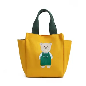 Gele canvas lunchtas met schattige berenprint, groene handvatten, stijlvolle bentotas voor dames.