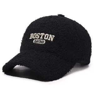 Detail view of black teddy fleece baseball cap featuring white Boston 1630 embroidery.