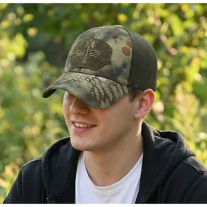 Detail view of the breathable tactical camo baseball cap worn outdoors, showing mesh panels.