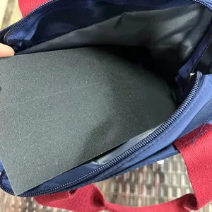 Large color-block lunch bag detail showing inner bottom support board and durable fabric.