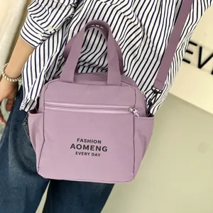 Detail view of the purple waterproof lunch bag showcasing front zipper pocket and shoulder strap.