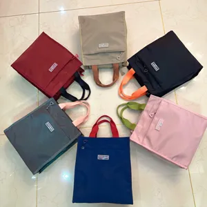 Large color block lunch bag portable waterproof tote bag for students and office workers daily use.