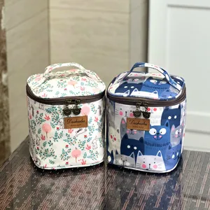 Cute printed insulated lunch bag and cosmetic storage box with dual zippers and handle.