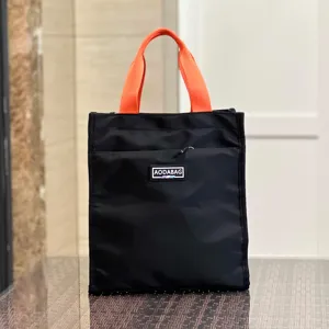 Black and orange large lunch tote bag detail, featuring durable fabric and front zipper pocket.