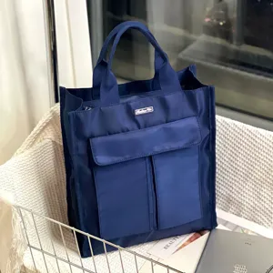 Detailed view of the multi-pocket dark blue utility tote bag in a cozy scene setup.